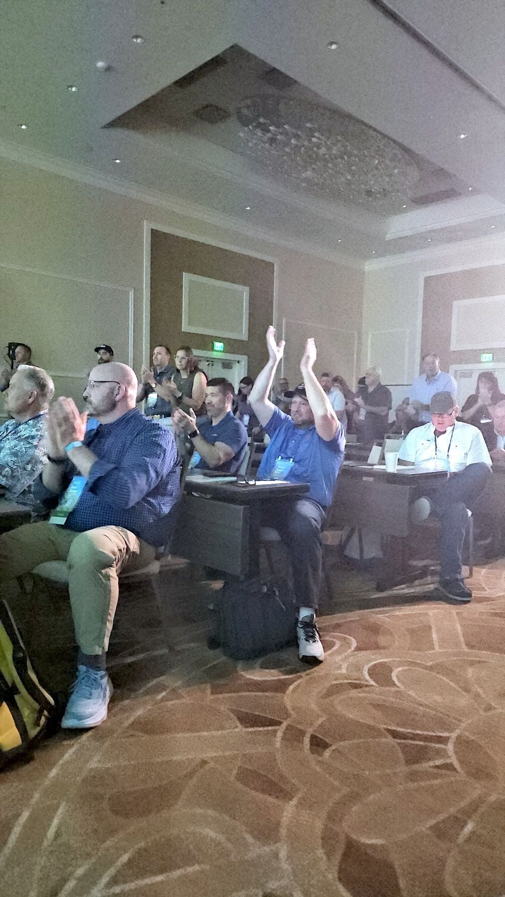 Members applauding during a RISE 2026 general session