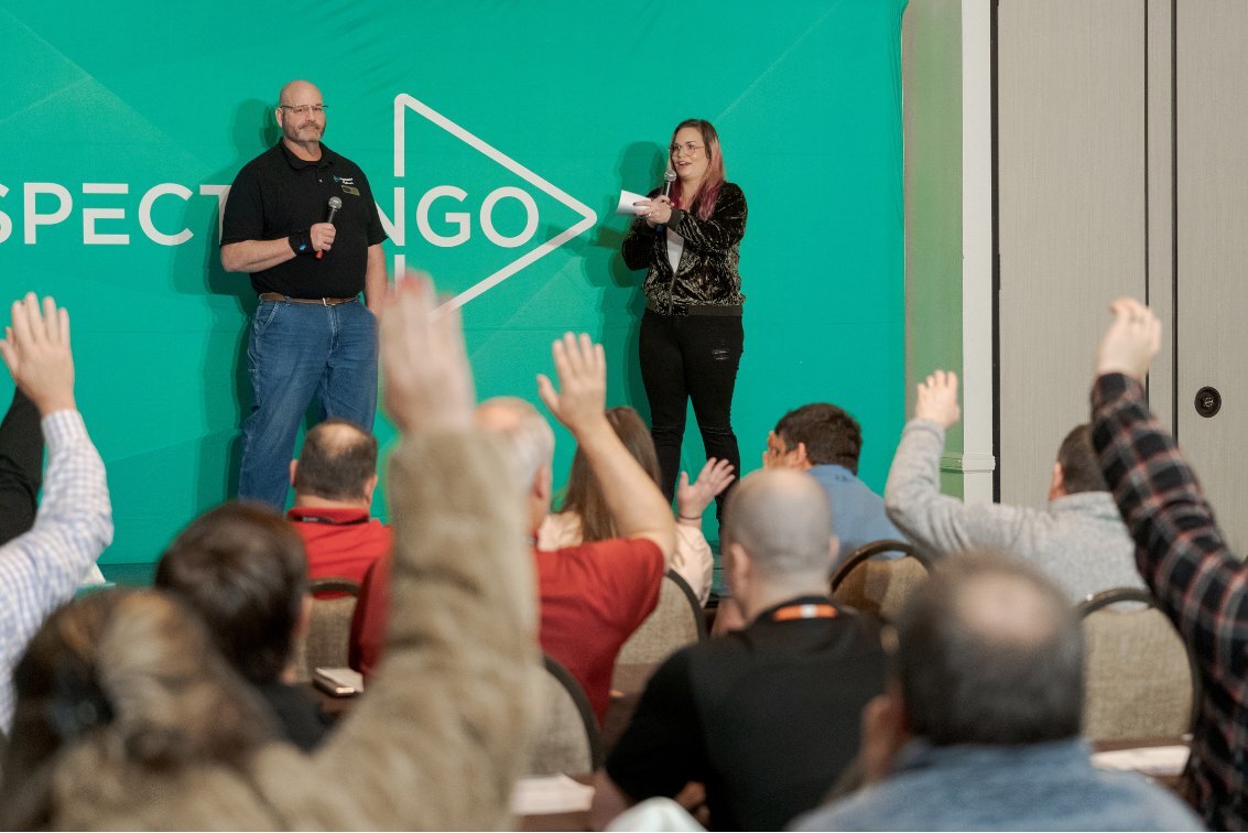 Owners raising hands during a session at an iGo conference